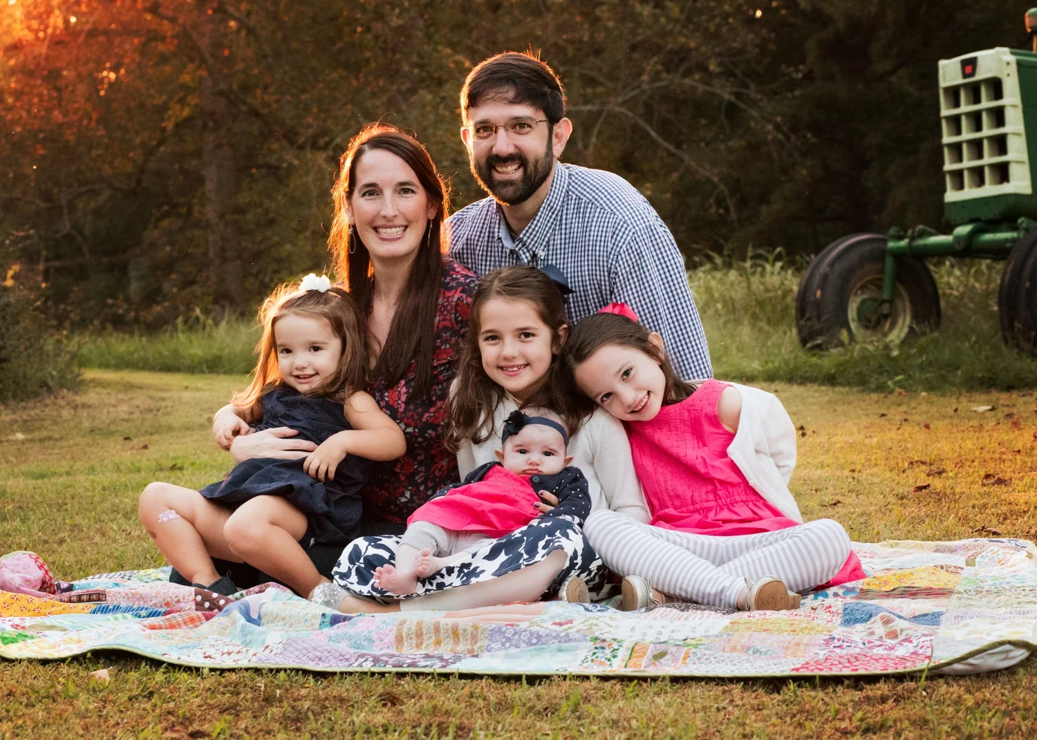 Four sister and their parents pose for family photo