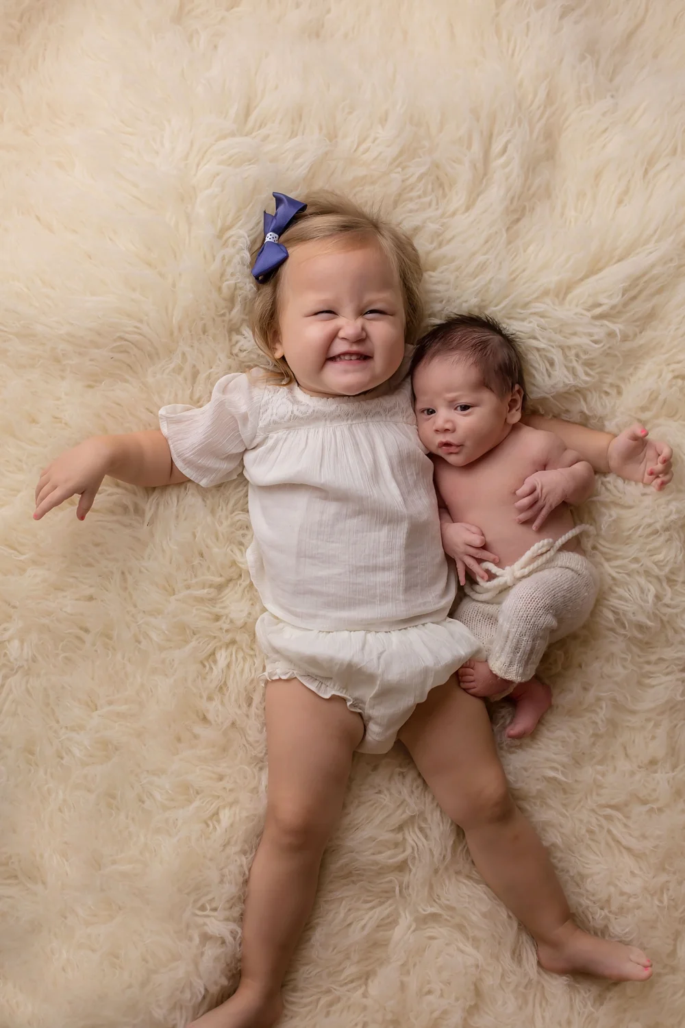 Big sister says cheese posing with newborn brother!