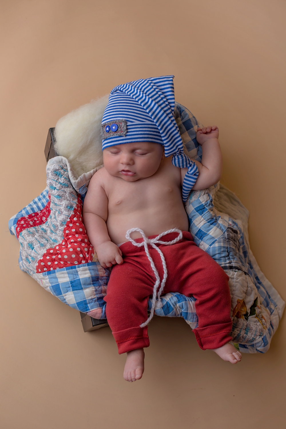 6 week old baby photo. baby in box with quilt piece.