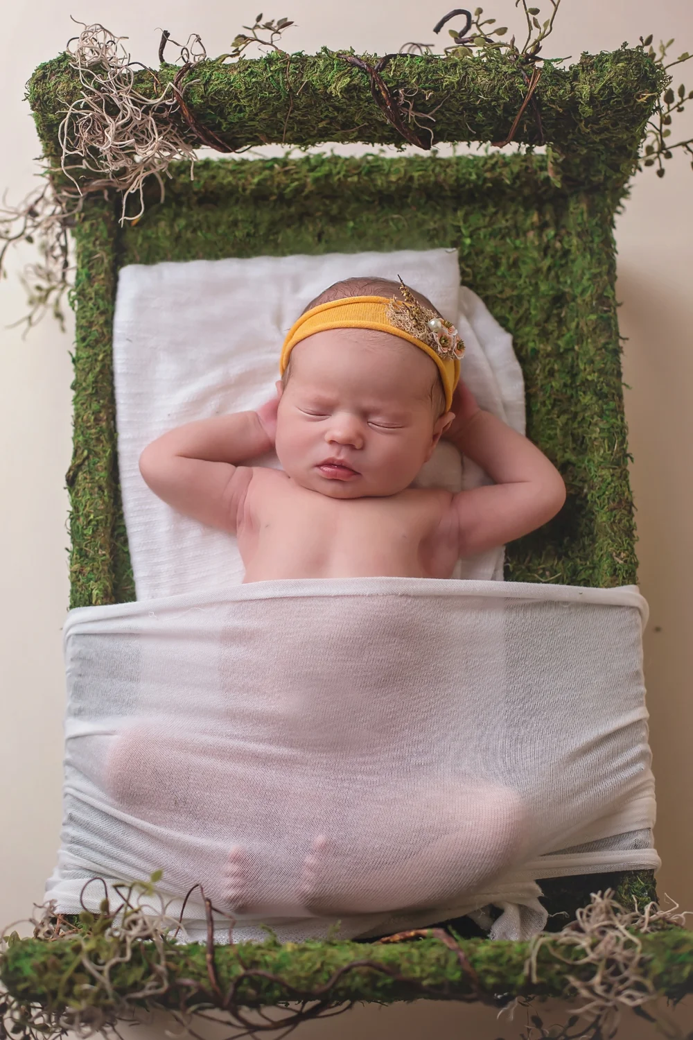 Newborn on moss prop bed - cute baby toes