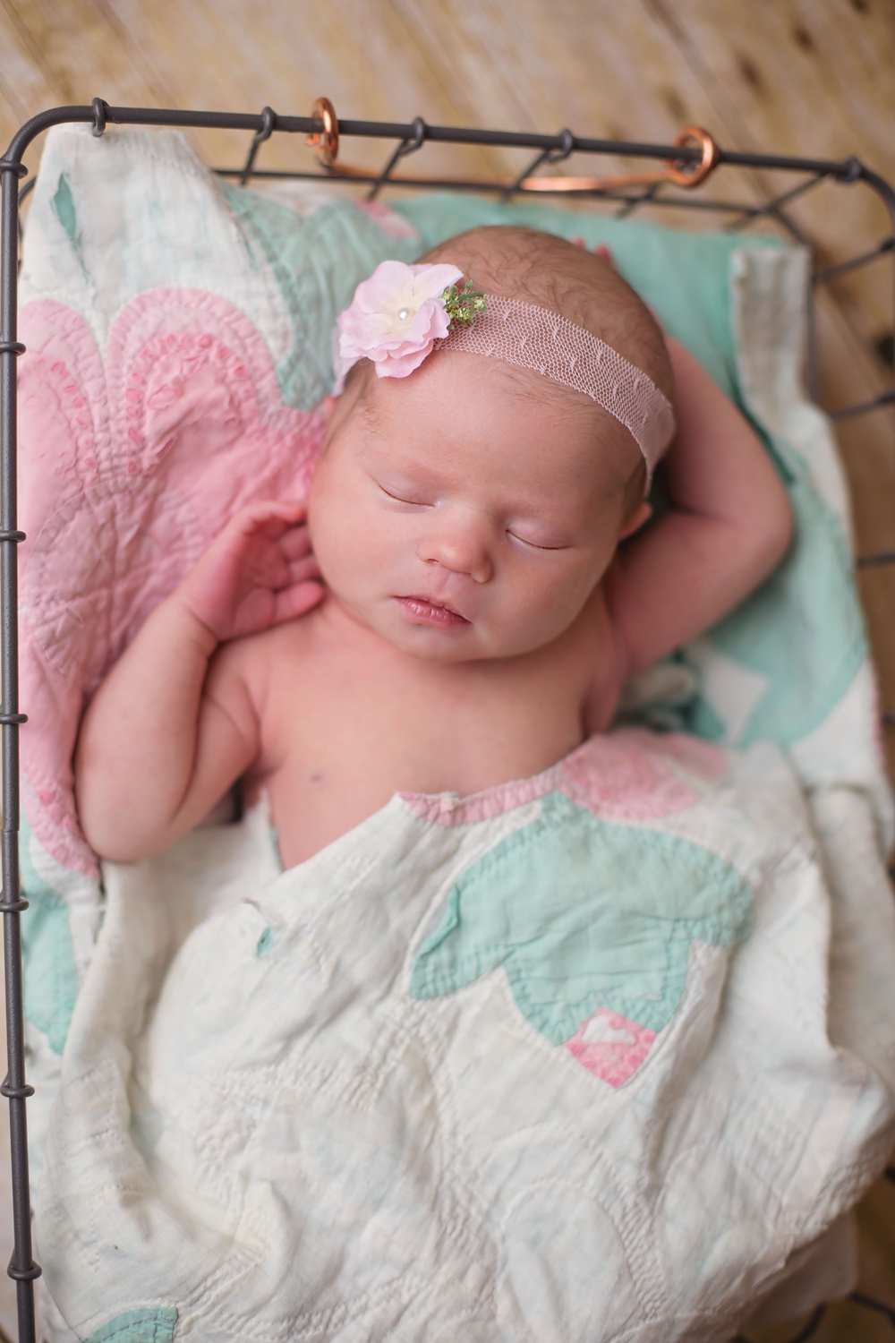 Overhead shot of newborn with old quilt piece.