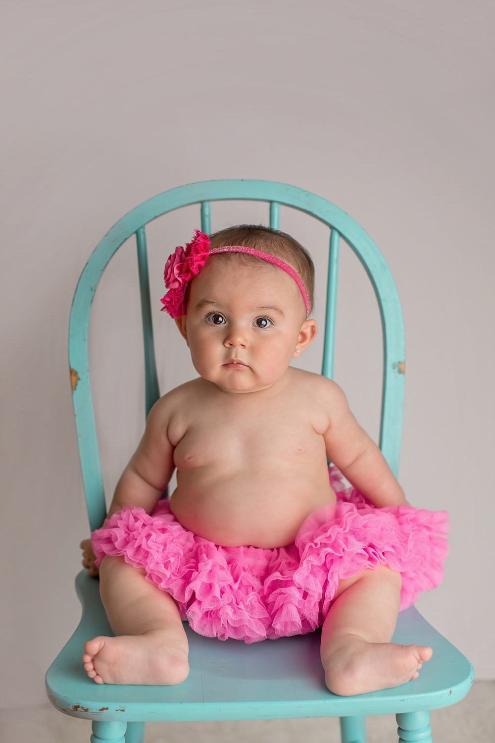 Milestone session 6 month old baby in pink tutu in teal chair