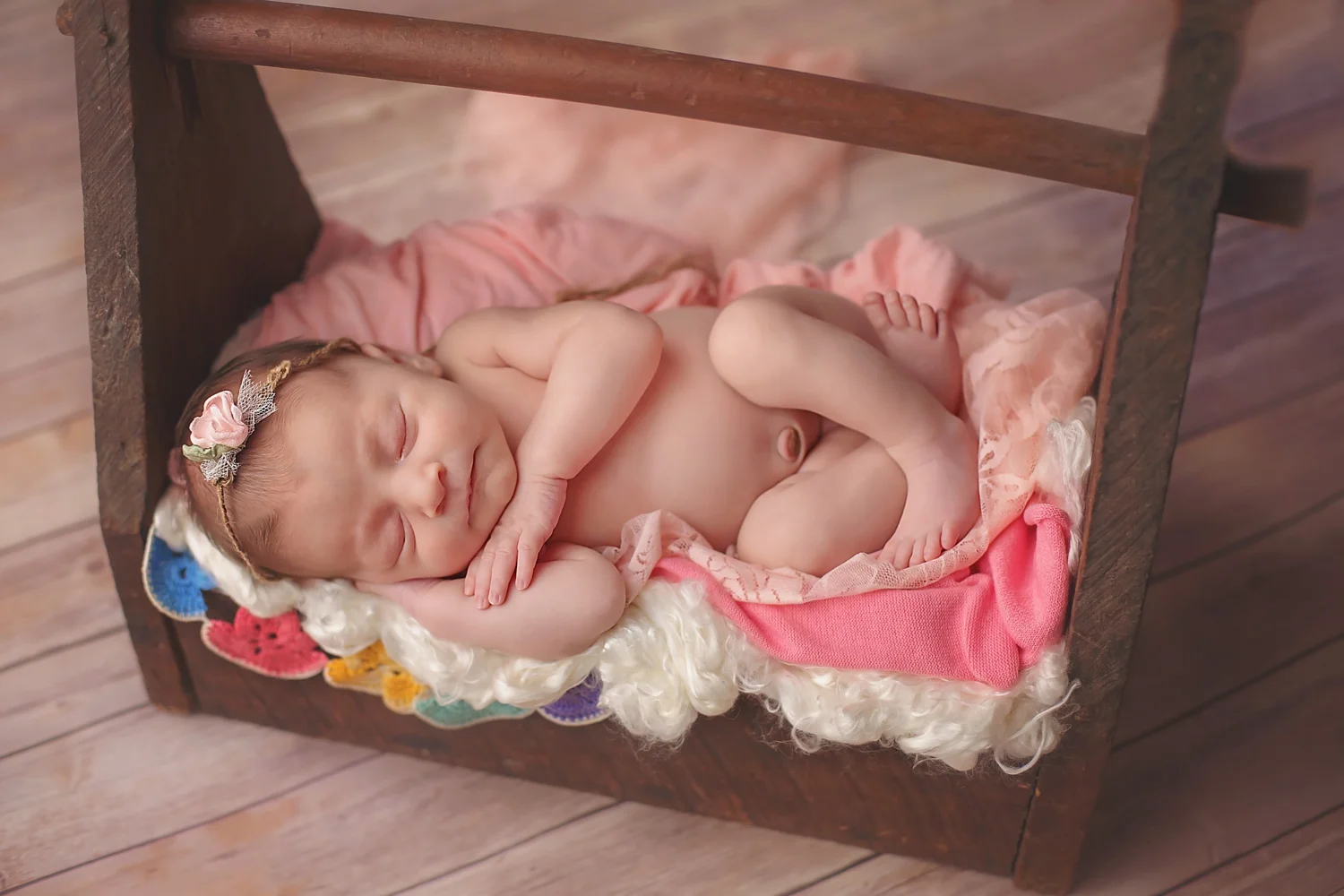Newborn in vintage prop tool box 