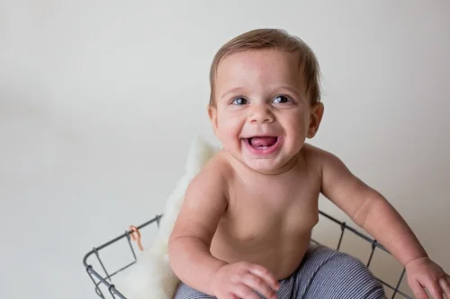 Studio session with Durham baby photographer has little boy smiling.