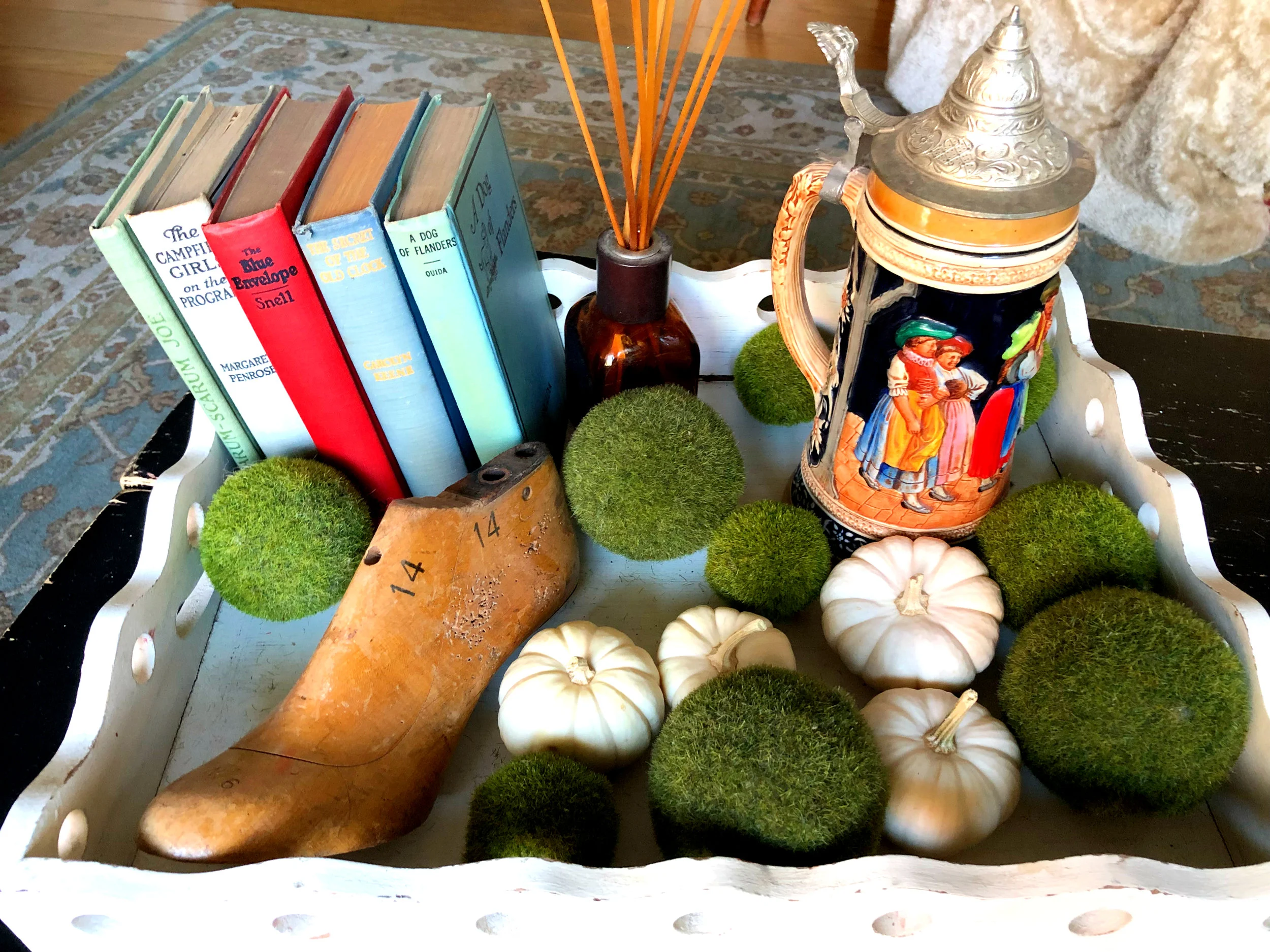 Tabletop beauty: wooden tray - Southern Living Home, old books from neighbor’s yard sale, antique shoe mold - a gift from my sister, a German beer stein, green balls from Homegoods, real white pumpkins from Trader Joe’s.