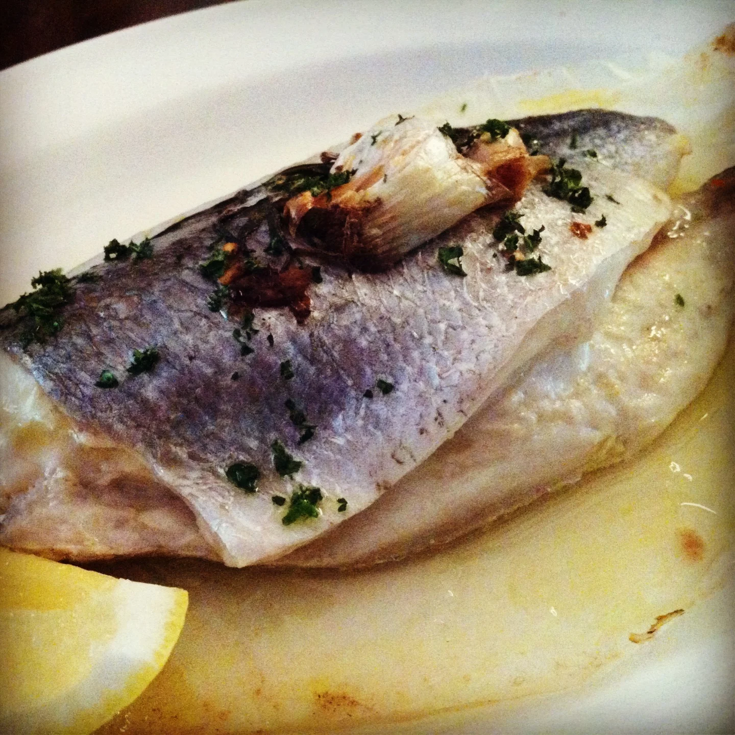 Royal bream baked in paper with garlic, rosemary and chilli