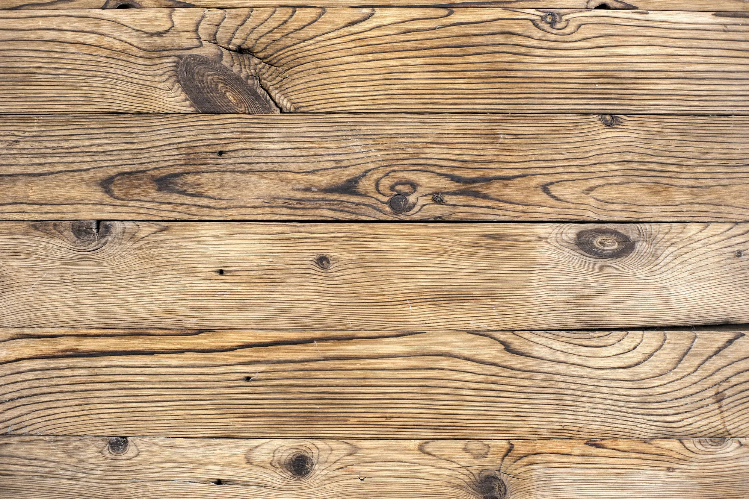 Close-up view of wooden planks with visible grain patterns, knots, and natural textures.