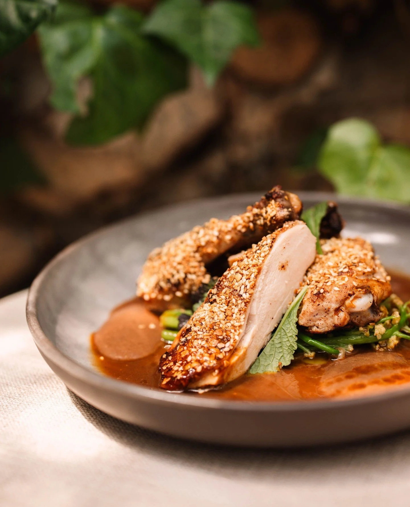 Our Mary&rsquo;s half chicken, slow cooked until tender, finished with crispy garlic and dukkah. Served with sprouting cauliflower, shallots, and a date and black garlic pur&eacute;e, then drizzled tableside with a rich roasted chicken jus. Simple in