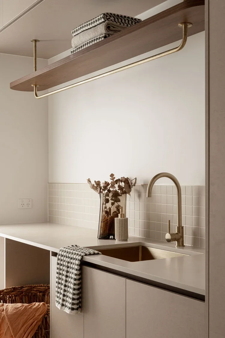 Utility room with built in hanging rail brass sink tap and ceramic basin bespoke laundry room design ideas