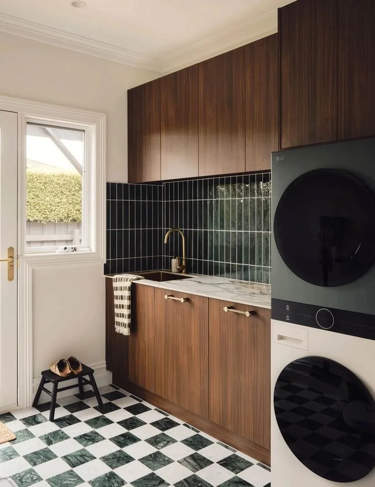 Bespoke utility room with dark walnut cabinetry, checkerboard floor tiles and integrated appliances interior design by Space A