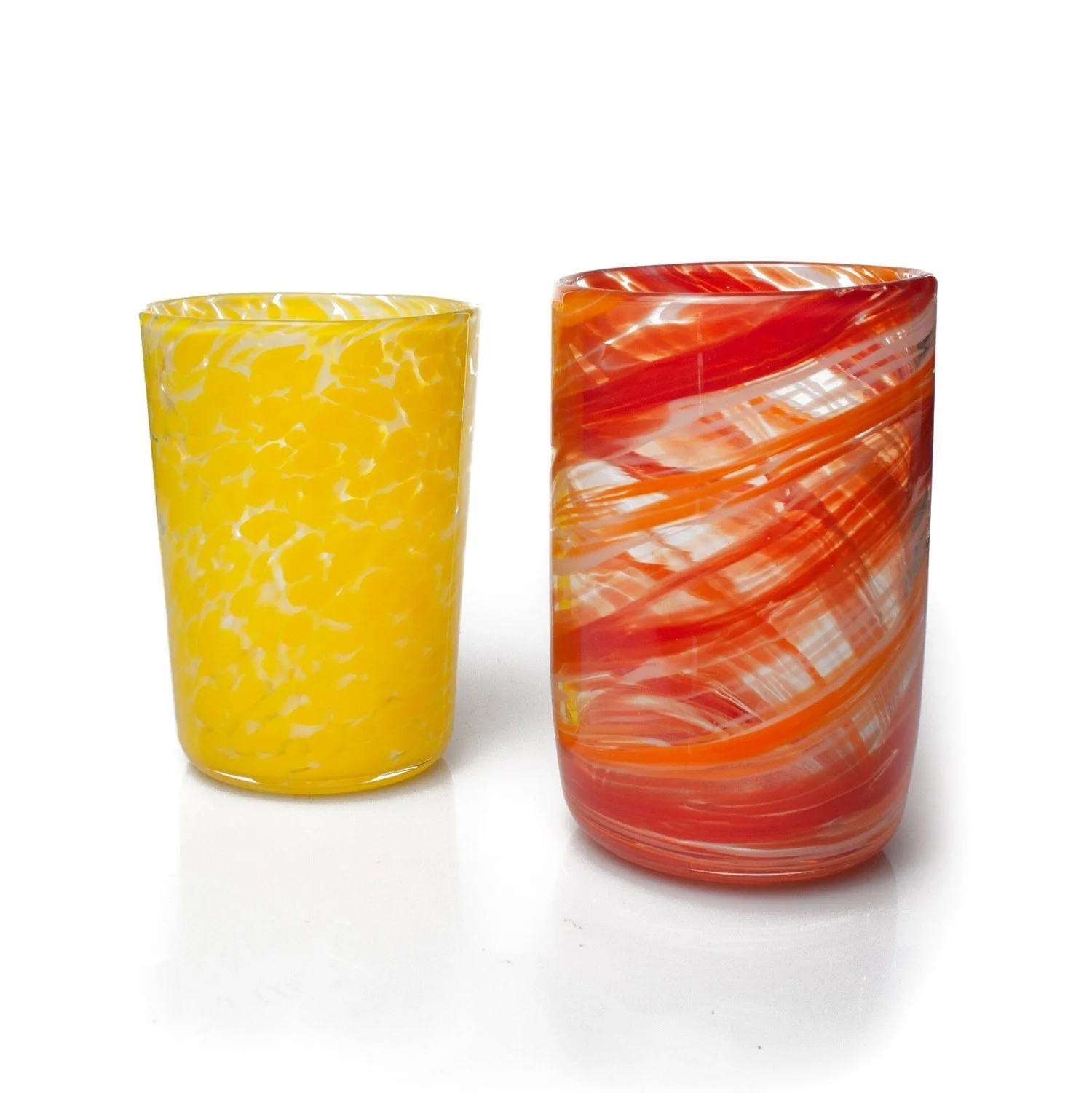 Two colorful glass tumblers, one yellow with white and yellow speckles, and one red with orange and white swirls, set against a white background.