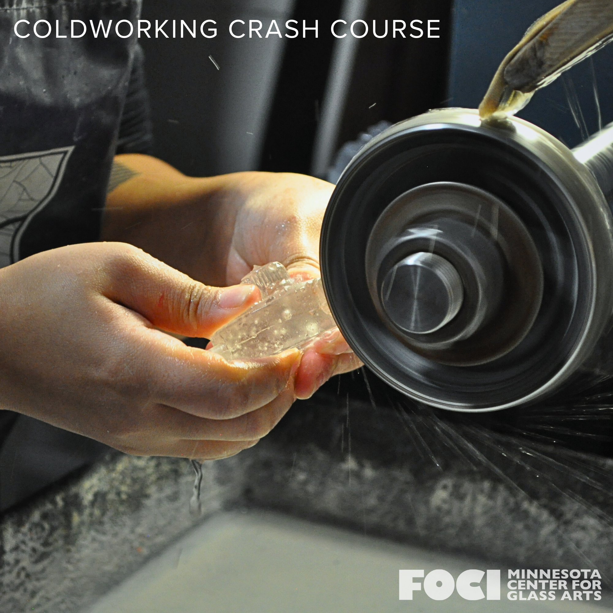 Person shaping glass at Coldworking Crash Course, using a spinning wheel on a glass piece.
