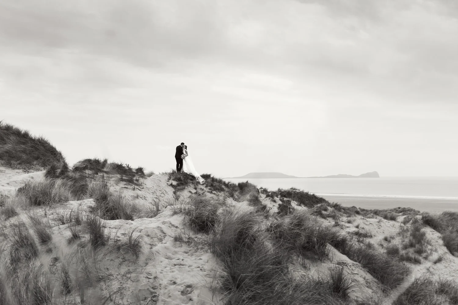 Wedding portraits at Llangennith beach, looking over towards Worm's head, Rhossili.
