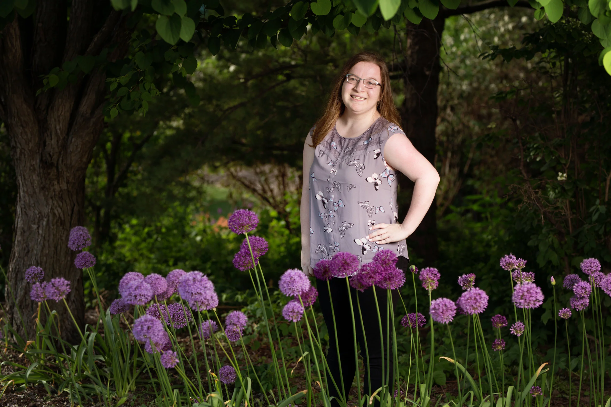 Senior picture of girl with beautiful purple flowers