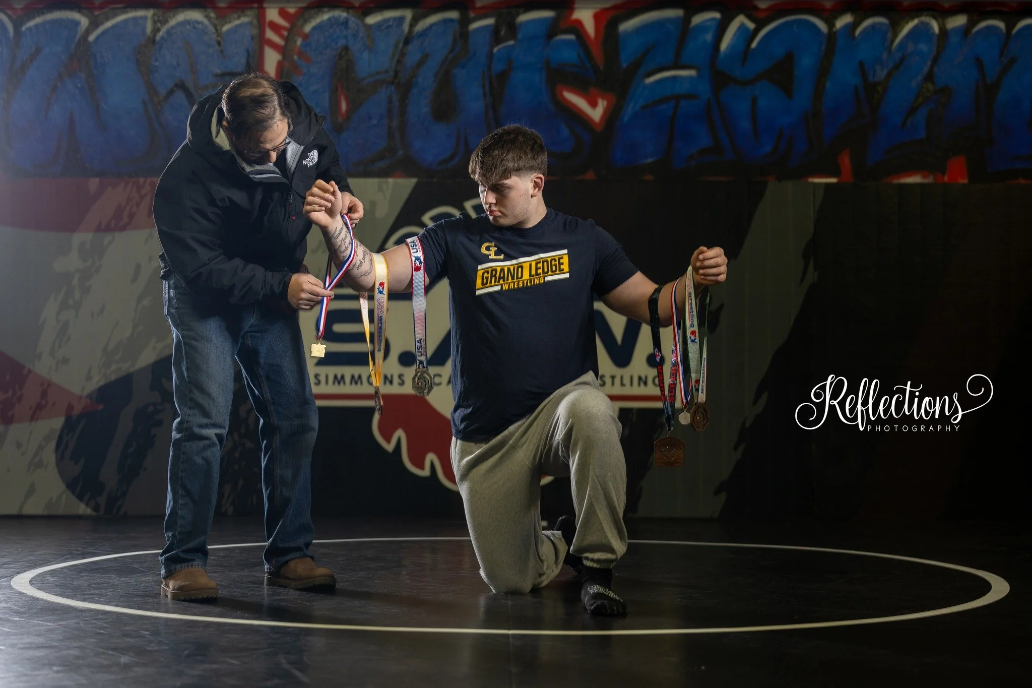 Before &amp; After: 
Logan&rsquo;s wrestling entrance, but make it senior photo. 
Step 1: Assemble the squad. 
Step 2: Wrestle with lighting equipment like it&rsquo;s regionals. 
Step 3: Unleash the smoke machine like we&rsquo;re summoning a wizard. 