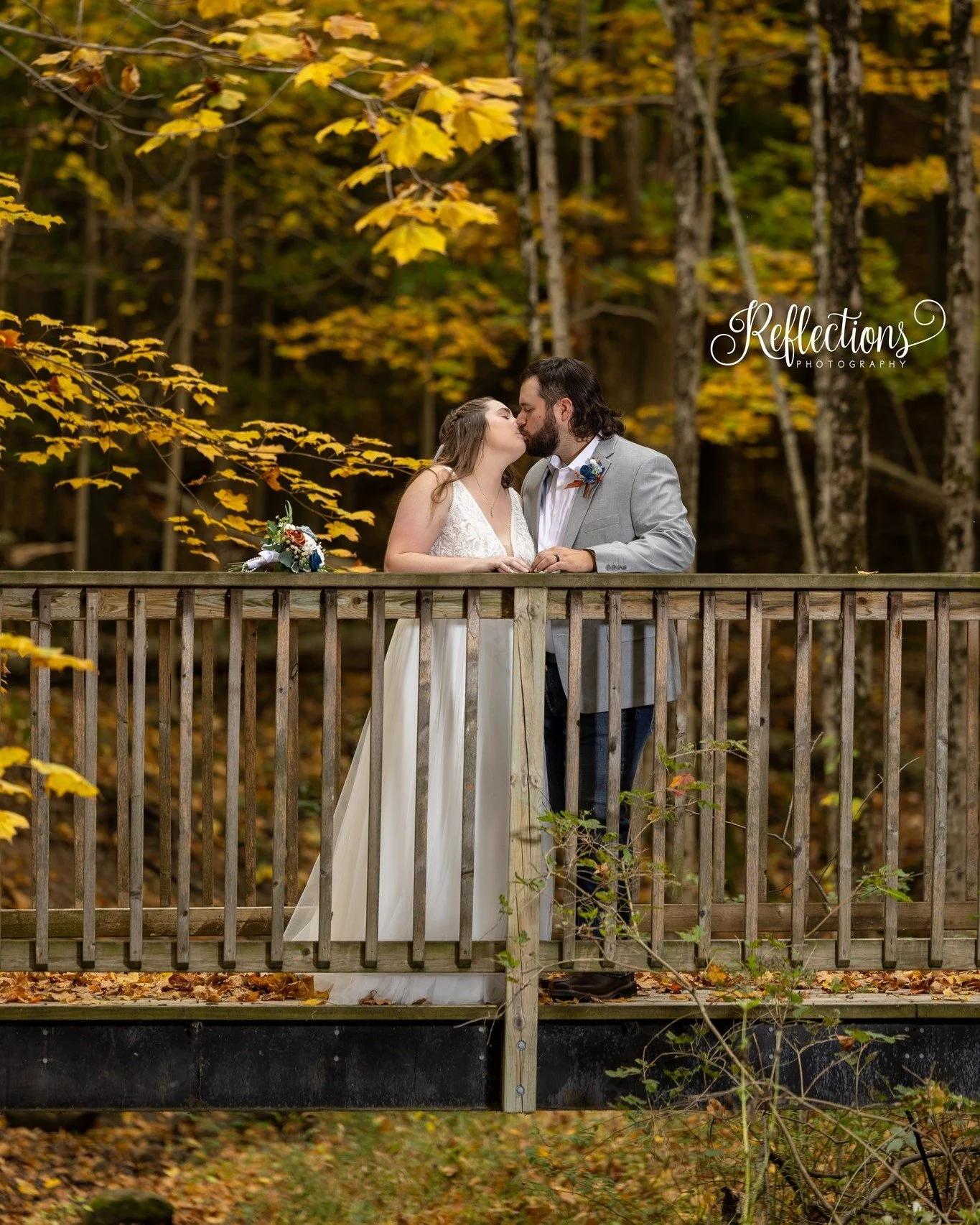 Taylor had a vision: &ldquo;Let&rsquo;s go down to the bridge for photos!&rdquo; 
So Trevor scooped up the train of her gown and helped her down the hill to the bridge. And there, wrapped in fall&rsquo;s golden glow, they shared this kiss on a bridge