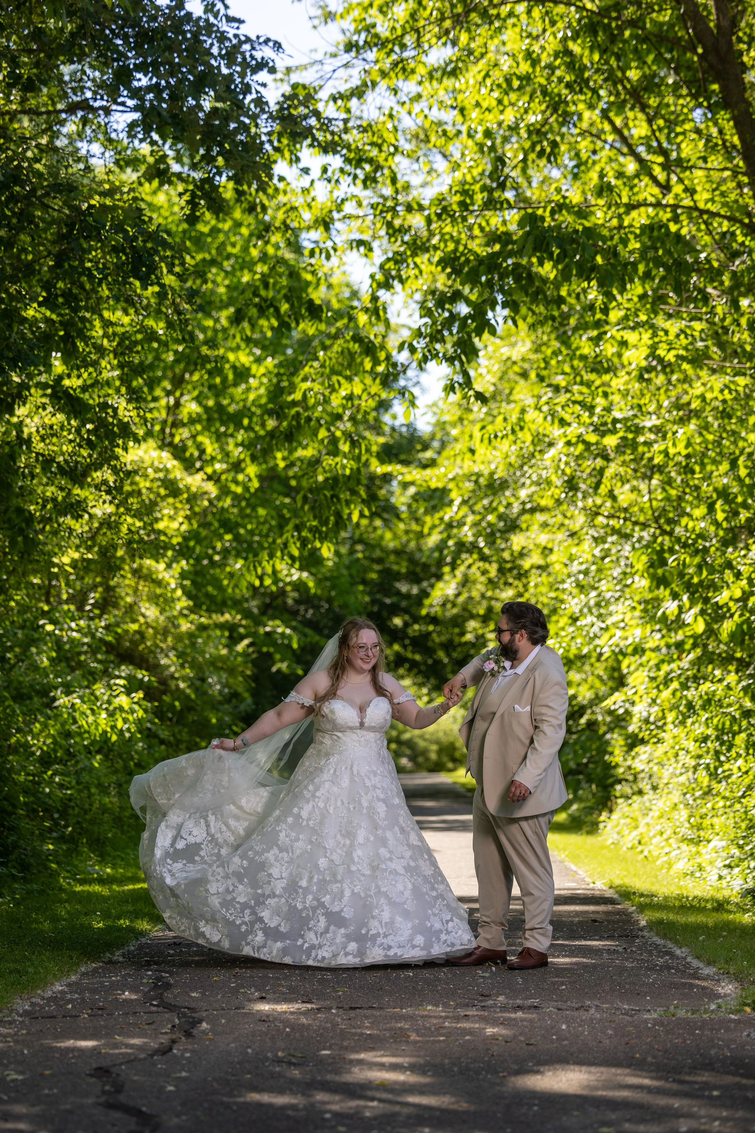 Bride and groom twirling photo