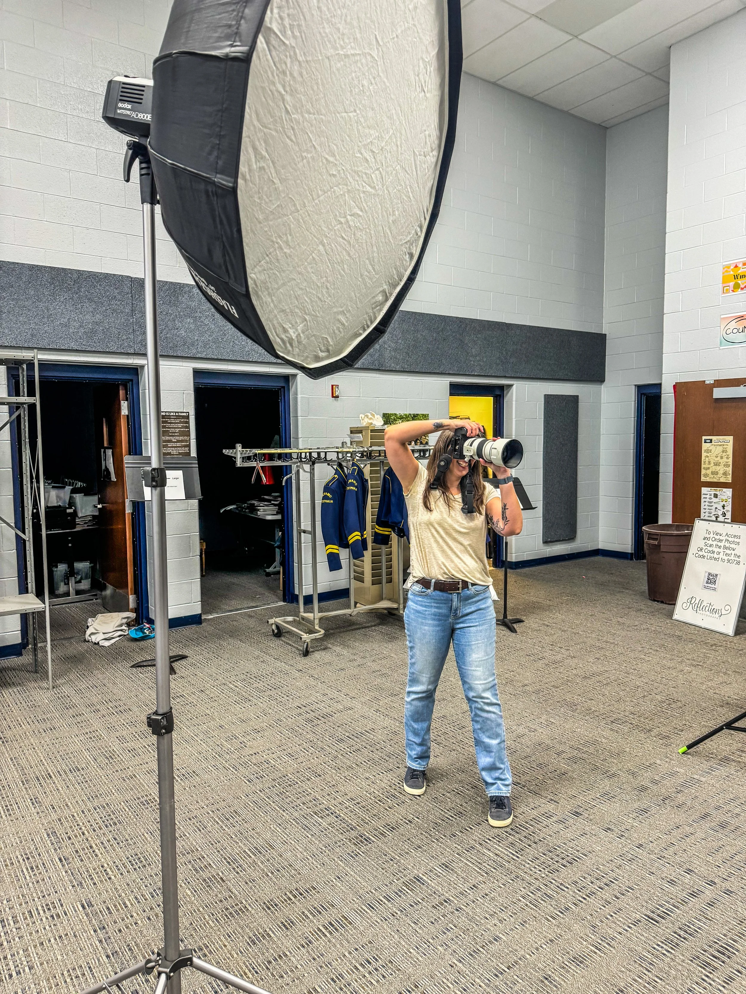 Photographer at a school taking portraits behind the scenes