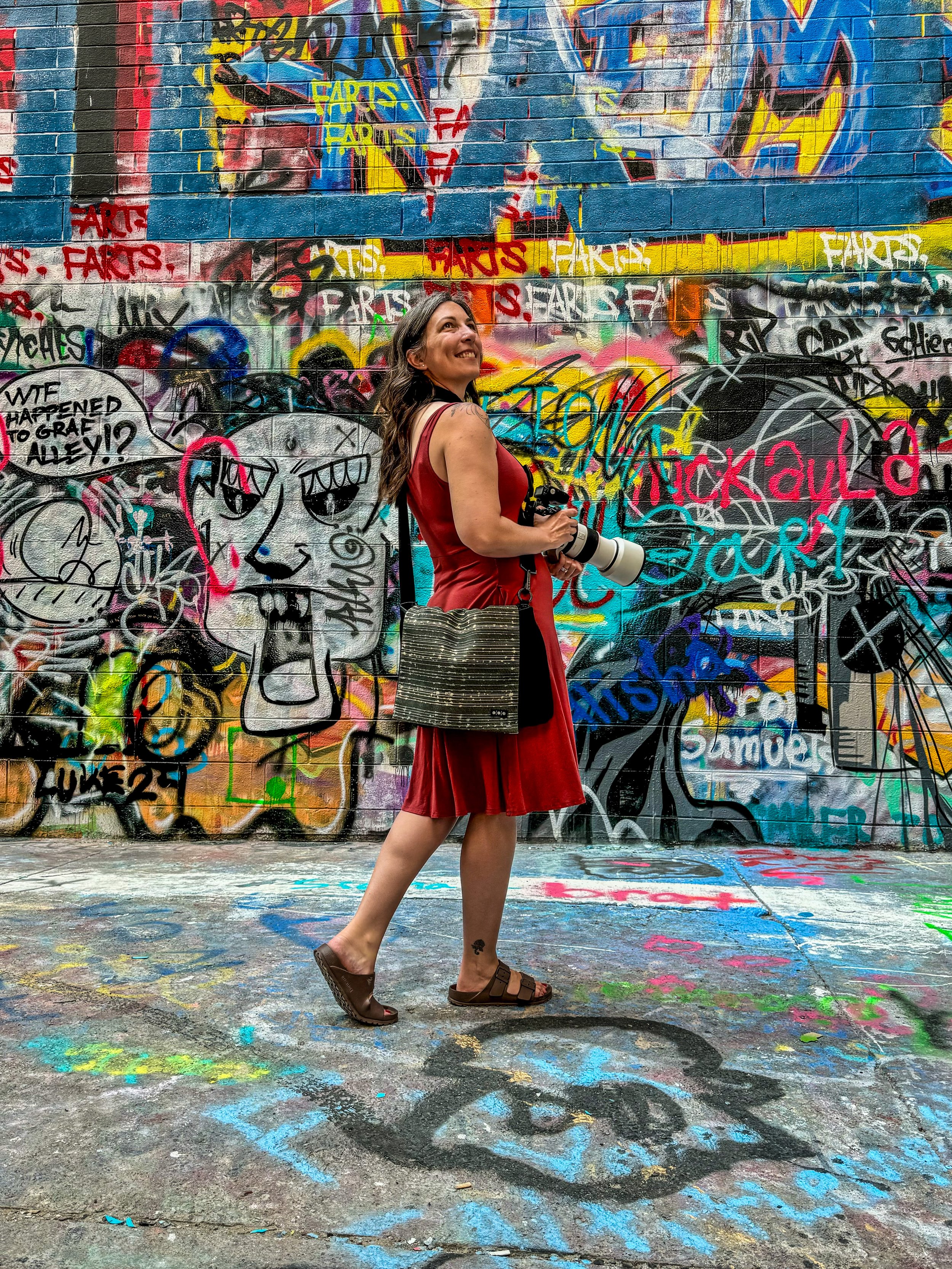 photographer walking near grafetti