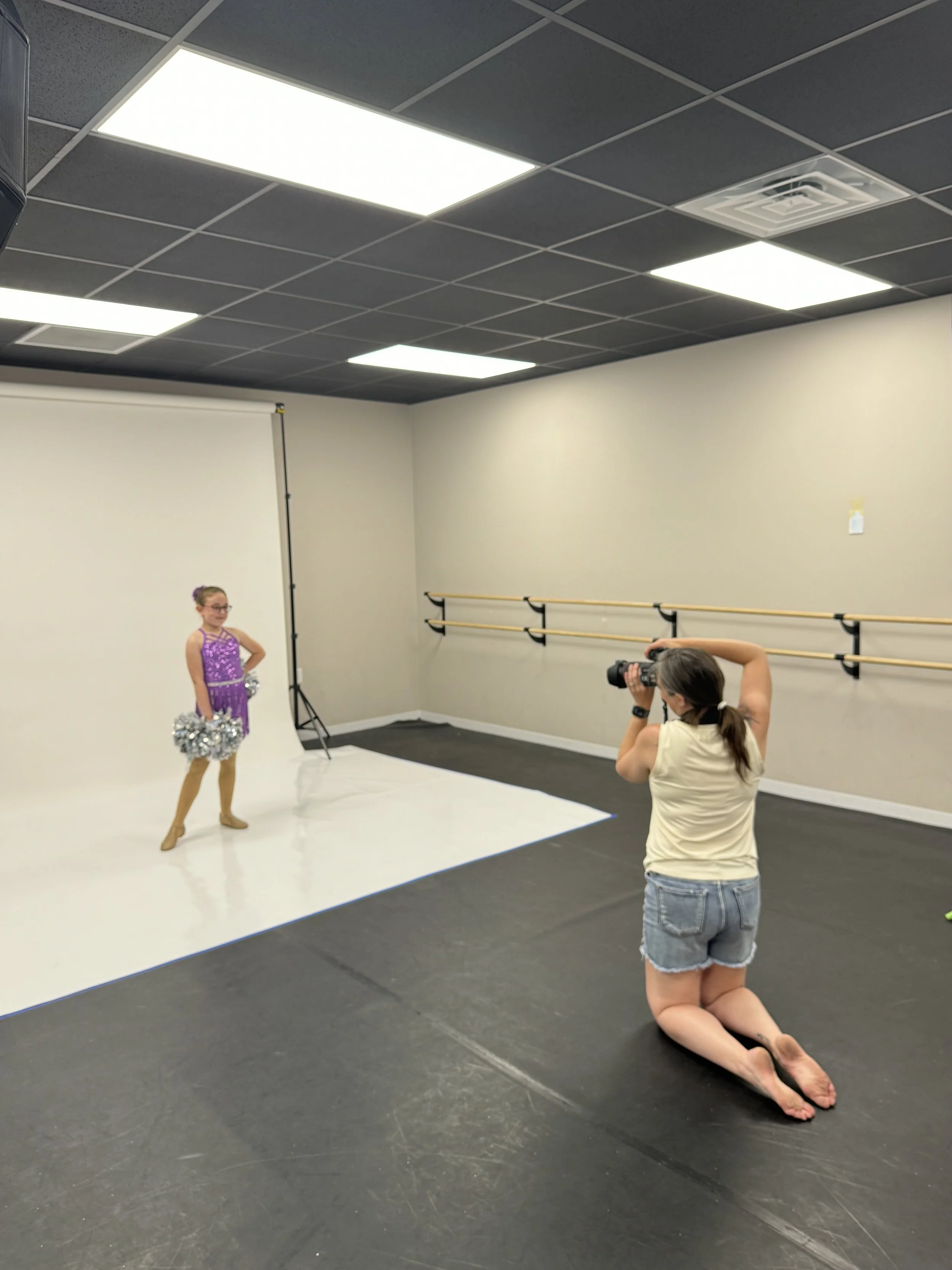photographer behind the scenes at a dance studio