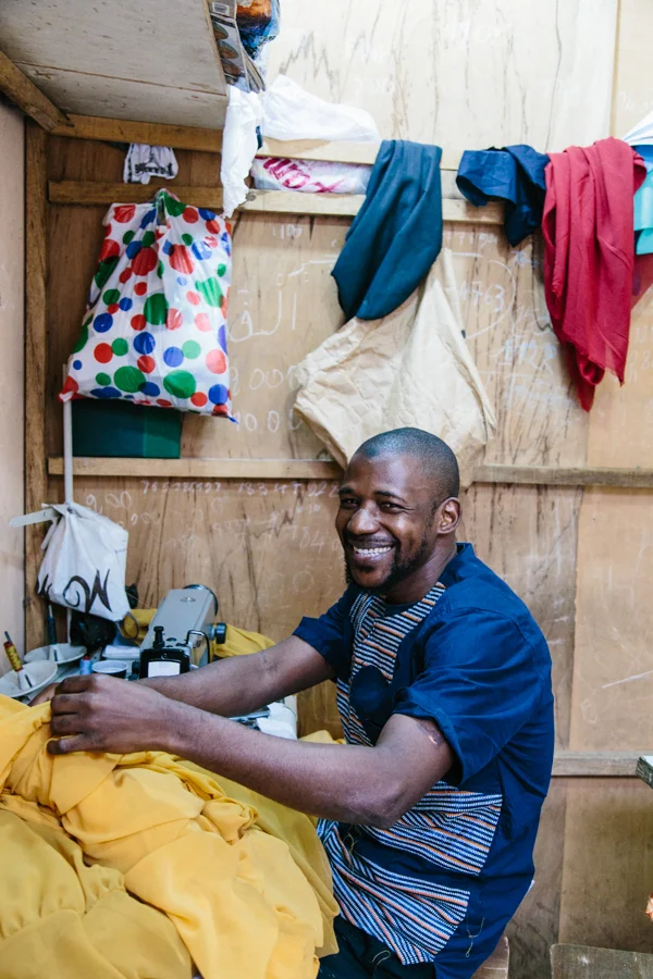 Alpha Ba, our lead tailor working in Dakar, Senegal.