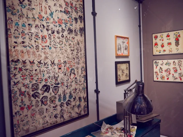 Tony D'Annessa's tattoo shop with original window shade flash used in the 1960's. Made to easily roll up if the police came looking for tattooists. In 1961, it became illegal in New York to be a tattooist.