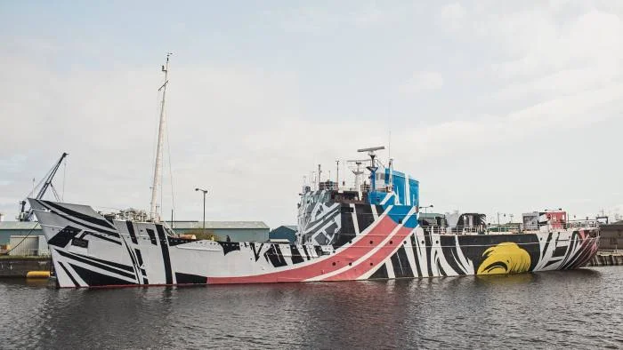 A contemporary dazzle ship docks in Leith