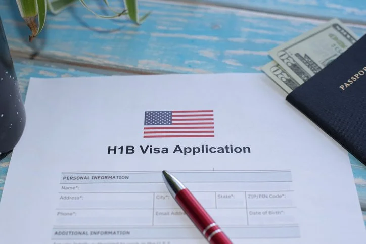 H-1B visa application form with passport and U.S. currency in San Francisco, CA