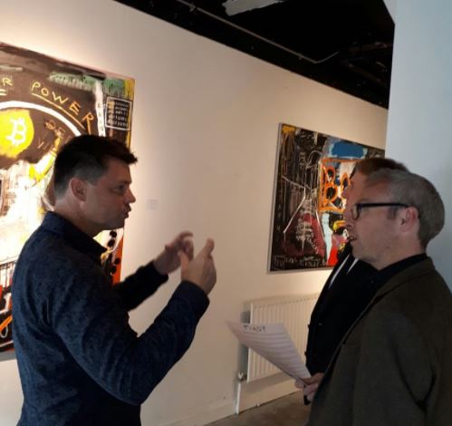 Talking neo-expressionist art to guests at Pigsy's solo exhibition in Dublin