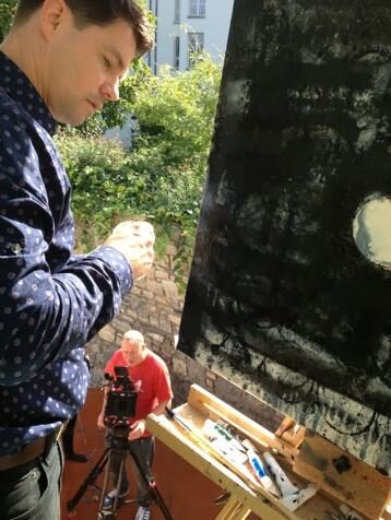 "Acting" Irish artist Pigsy being filmed painting for HGTV in an episode of Extreme Homes of the World when his Dublin home was featured