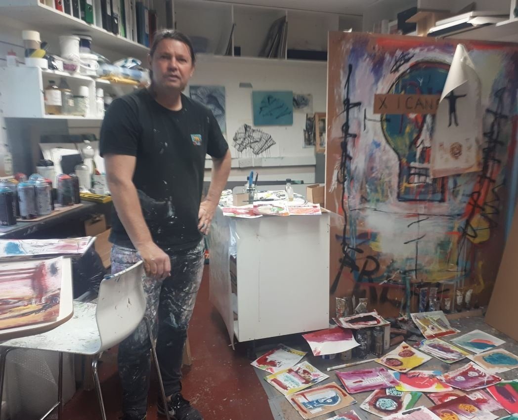 Artist PIGSY the alter ego of Ciaran McCoy stands in his Ranelagh Art Studio