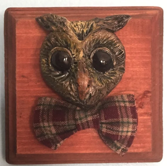 WHO ME? This mounted owl head was sculpted out of clay, then painted by hand. His bow tie was sewn out of vintage cloth. The wood panel he is mounted on is 6" x 6".