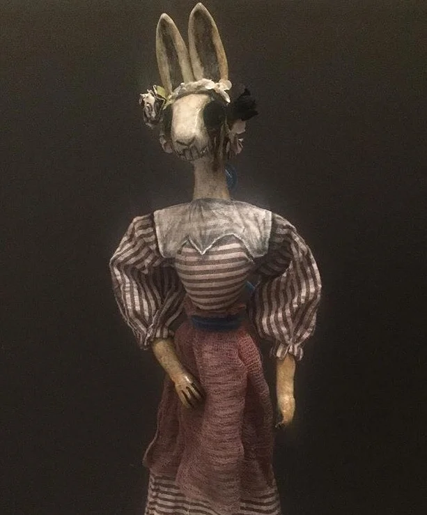 FRIDA RABBIT This little Rabbit was created in the Day of the Dead Style. Cone puppets are set inside decorative cones. The puppeteer can pop the puppet in and out of the cone and swirl to make the puppet dance. The head and hands are sculpted with clay. Body made with wire so the arms can move. Costume hand sewn using vintage and new fabric.