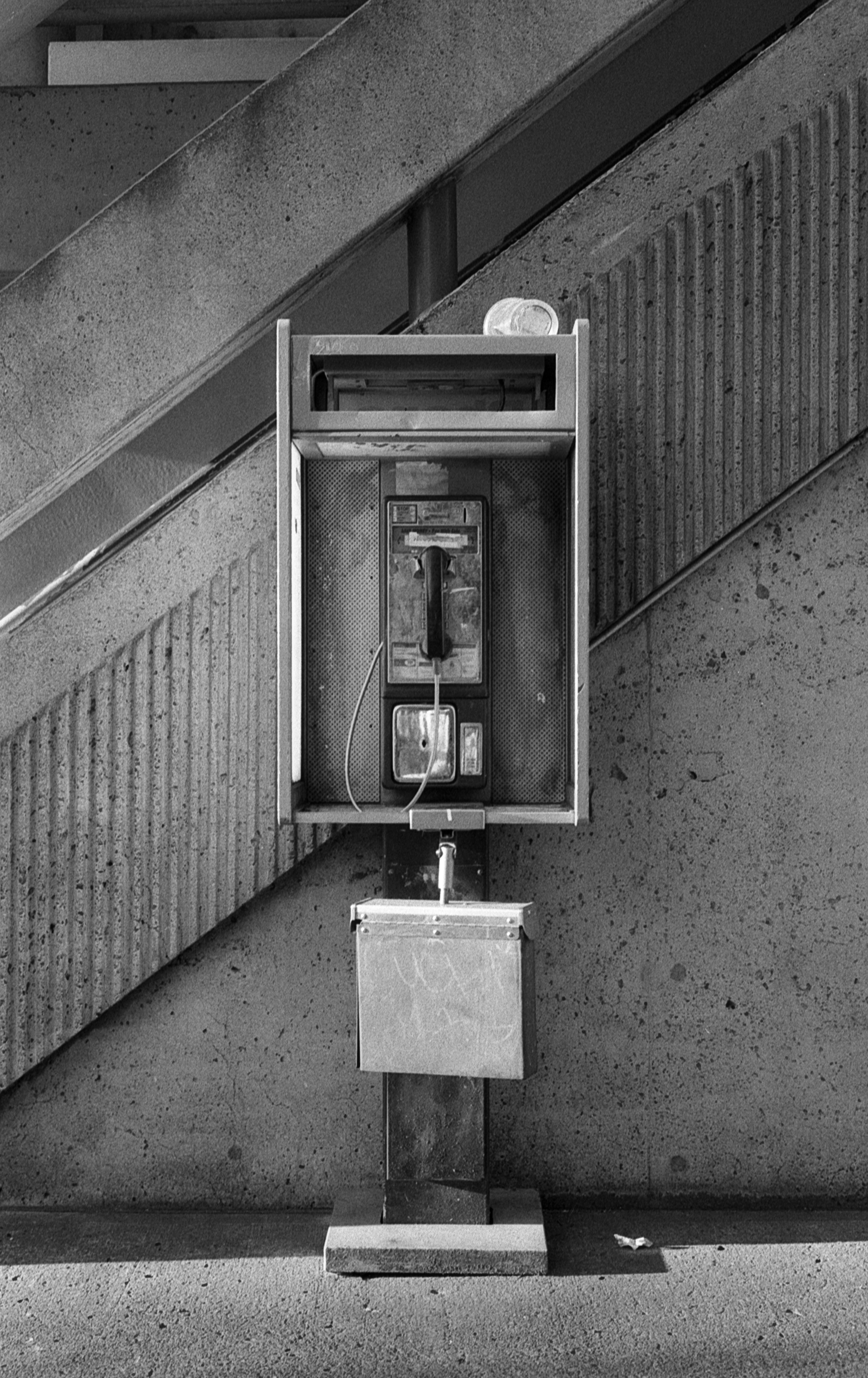 The way the light was hitting this phone box caught my eye as it emphasized the graphic blocking of the stairwell behind it and how it aligns with the phone box. I took some digital shots as well as this shot on HP5+ but it was this one that really stood out.