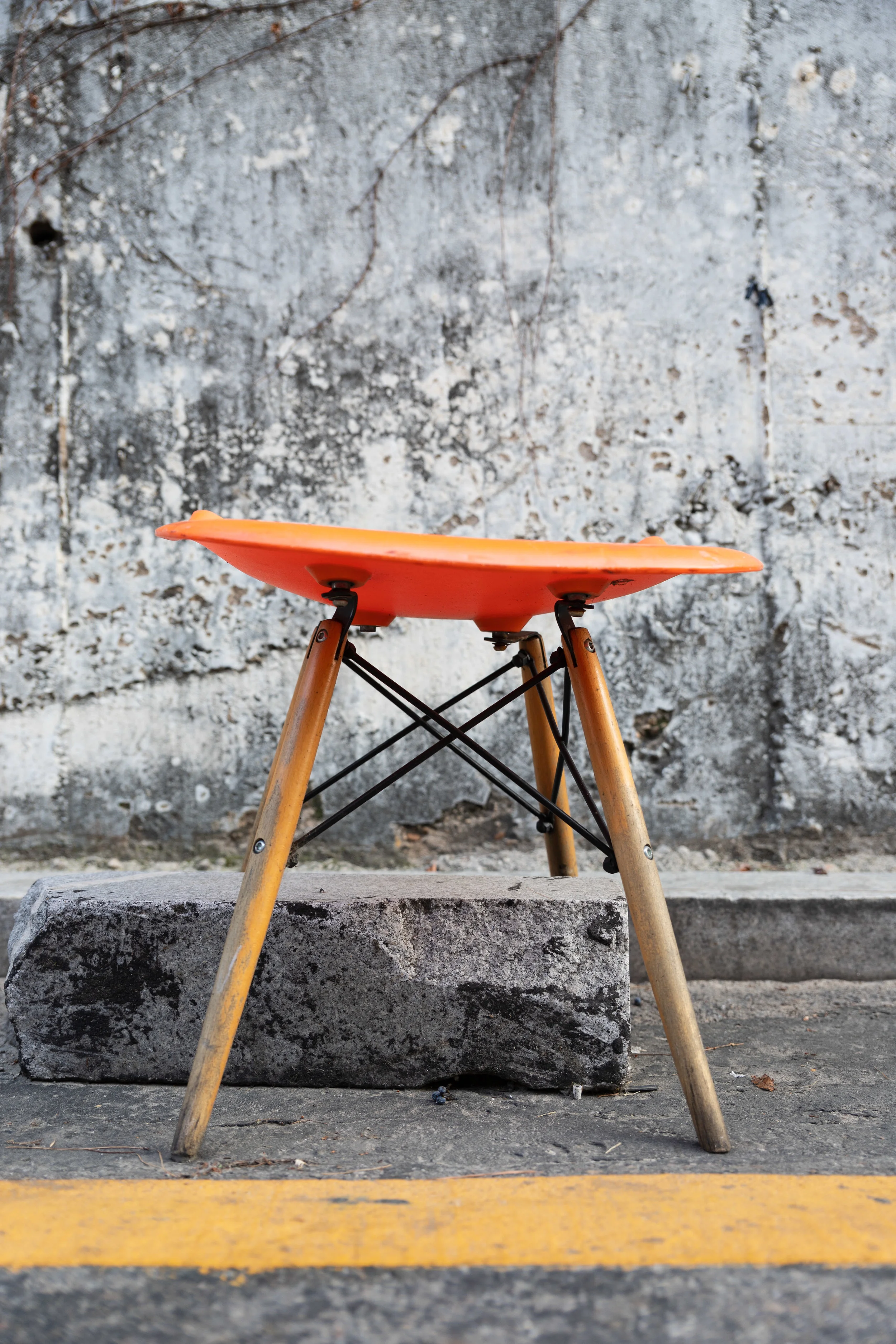 I came upon a row of half-broken stools that had been left out in front of an interestingly textured wall on a back street between Apujeong and Gangnam. The colour on this orange one worked especially well with the greys of the wall and road, and the block beneath the stool helps too. The subject could be either the stool and the road marking or the shades and textures of grey.