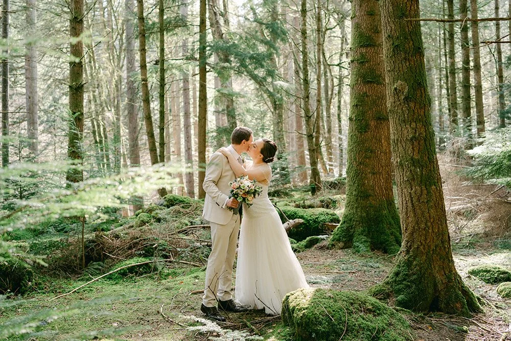 Wedding couple embracing in the forest at Dunkeld.jpg