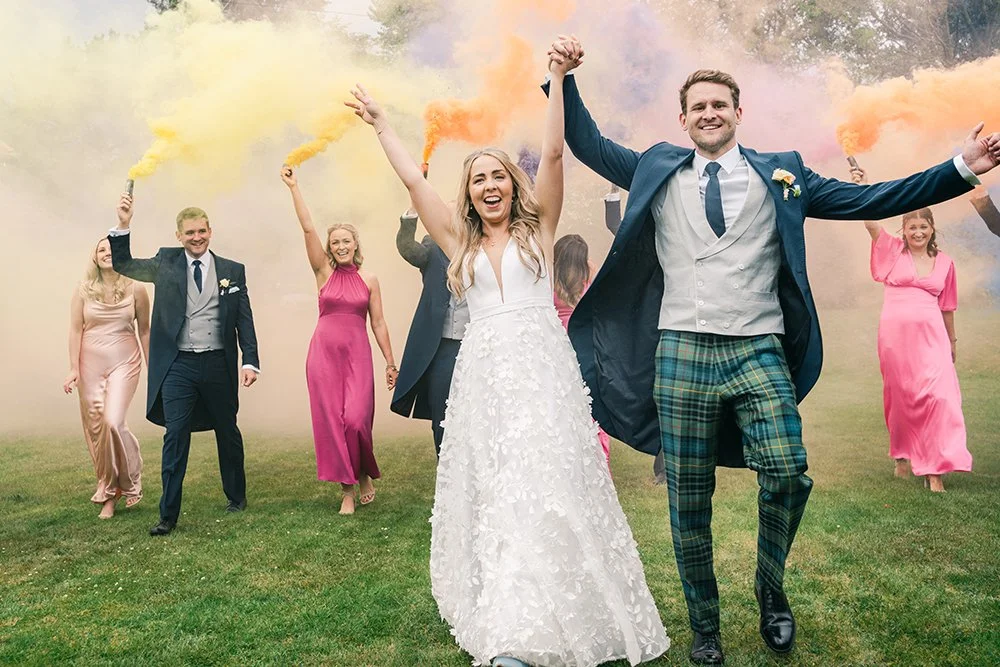 Wedding party laughing in Edinburgh with coloured smoke.jpg