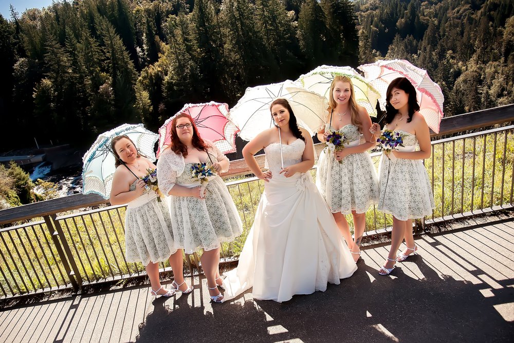 Bride & Bridesmaids with Umbrellas Looking Sassy.jpg
