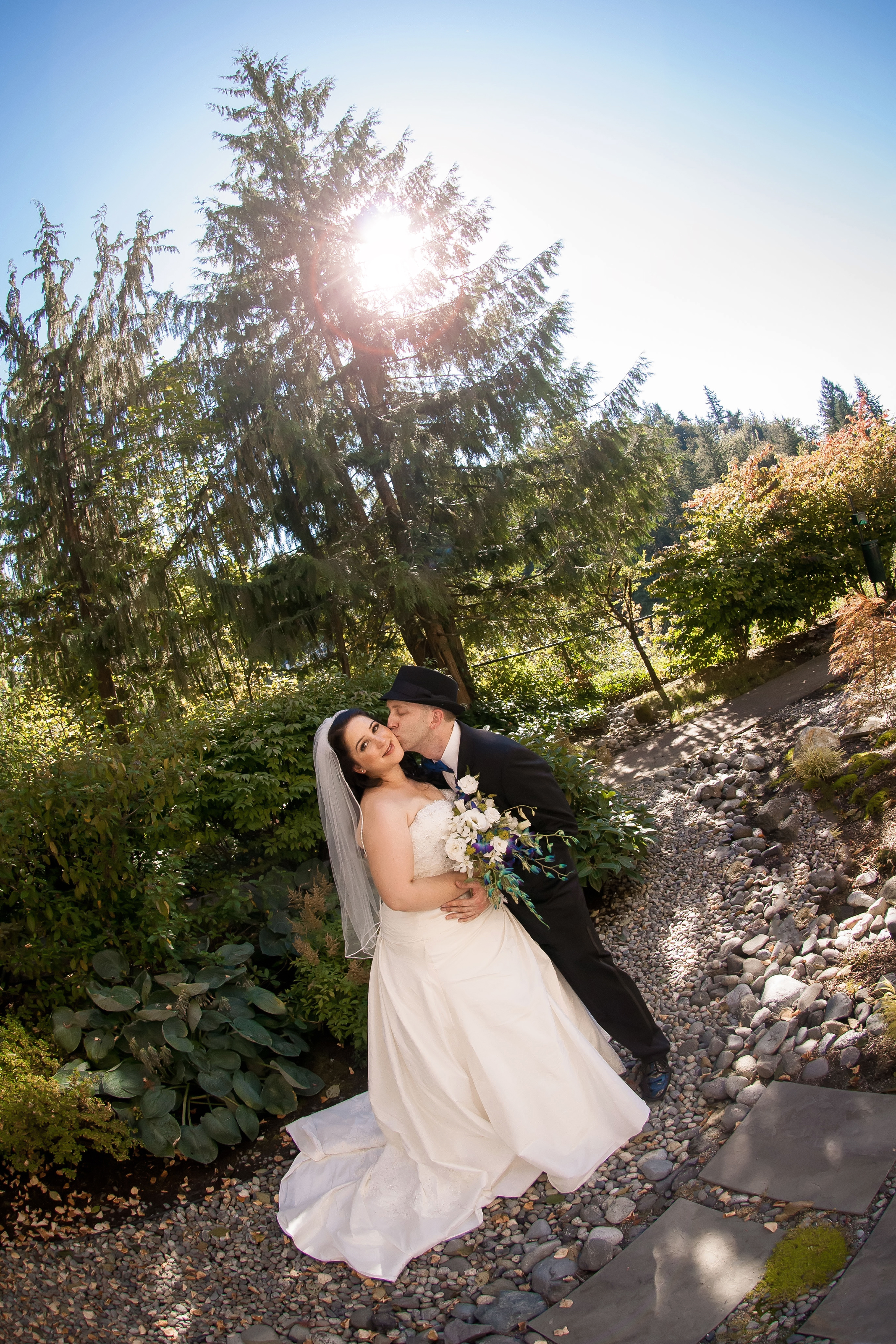 Bride & Groom Cheek Kiss Outside Garden.jpg