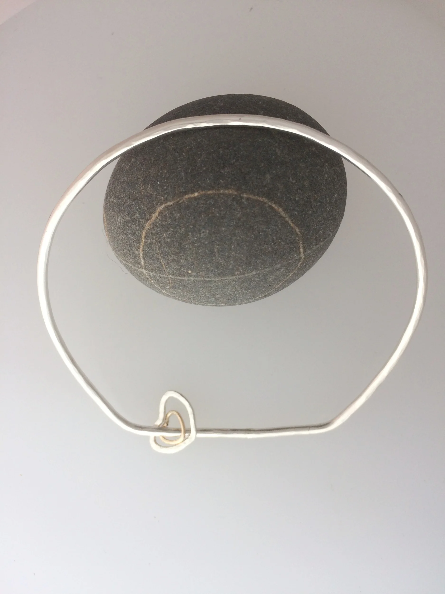 Silver bangle with heart-shaped spinners