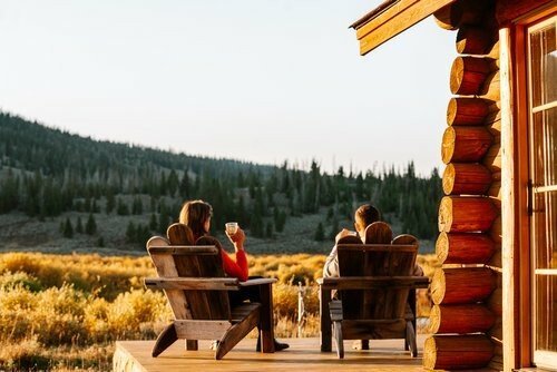 Guests Enjoying Drinks on Adirondack Chairs at Darwin Ranch Near Jackson Hole, Wyoming