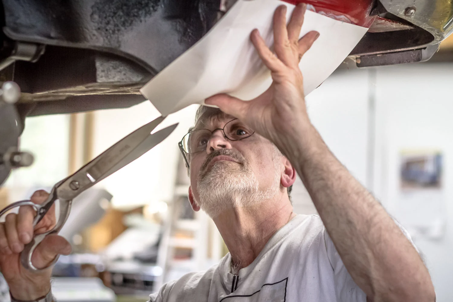 Jim creating a paper template for a metal part to be hand-shaped out of steel.