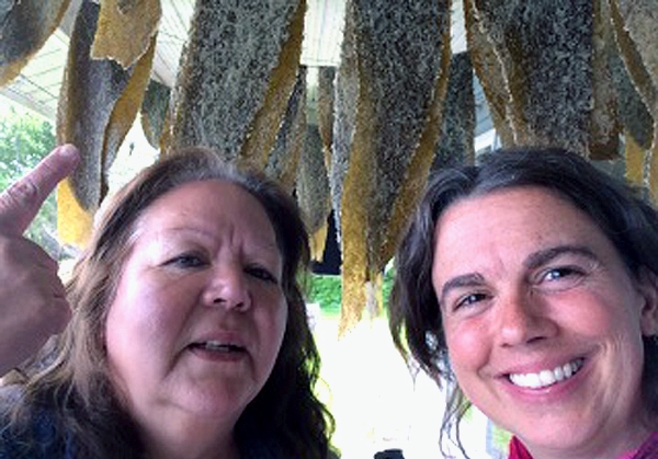 Jenny Cross (left) and Shelly Crack (right) on Jenny's ocean-side porch where freshly caught fish are drying. Source: Shelly Crack