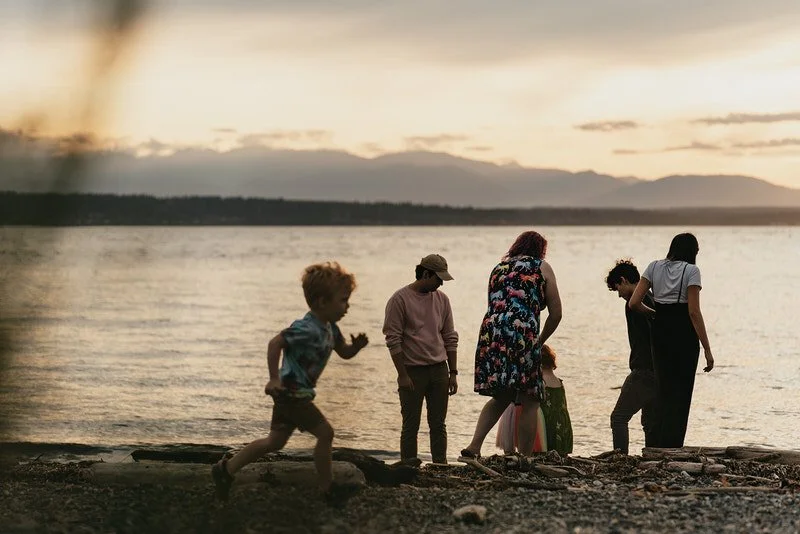 a blended family plays together on a beach