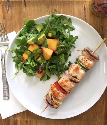 Simple salmon skewer with onions and red and green peppers. I just grilled this right on a stove-top griddle. And served with an arugula salad with avocado and peach... lemon vinaigrette.