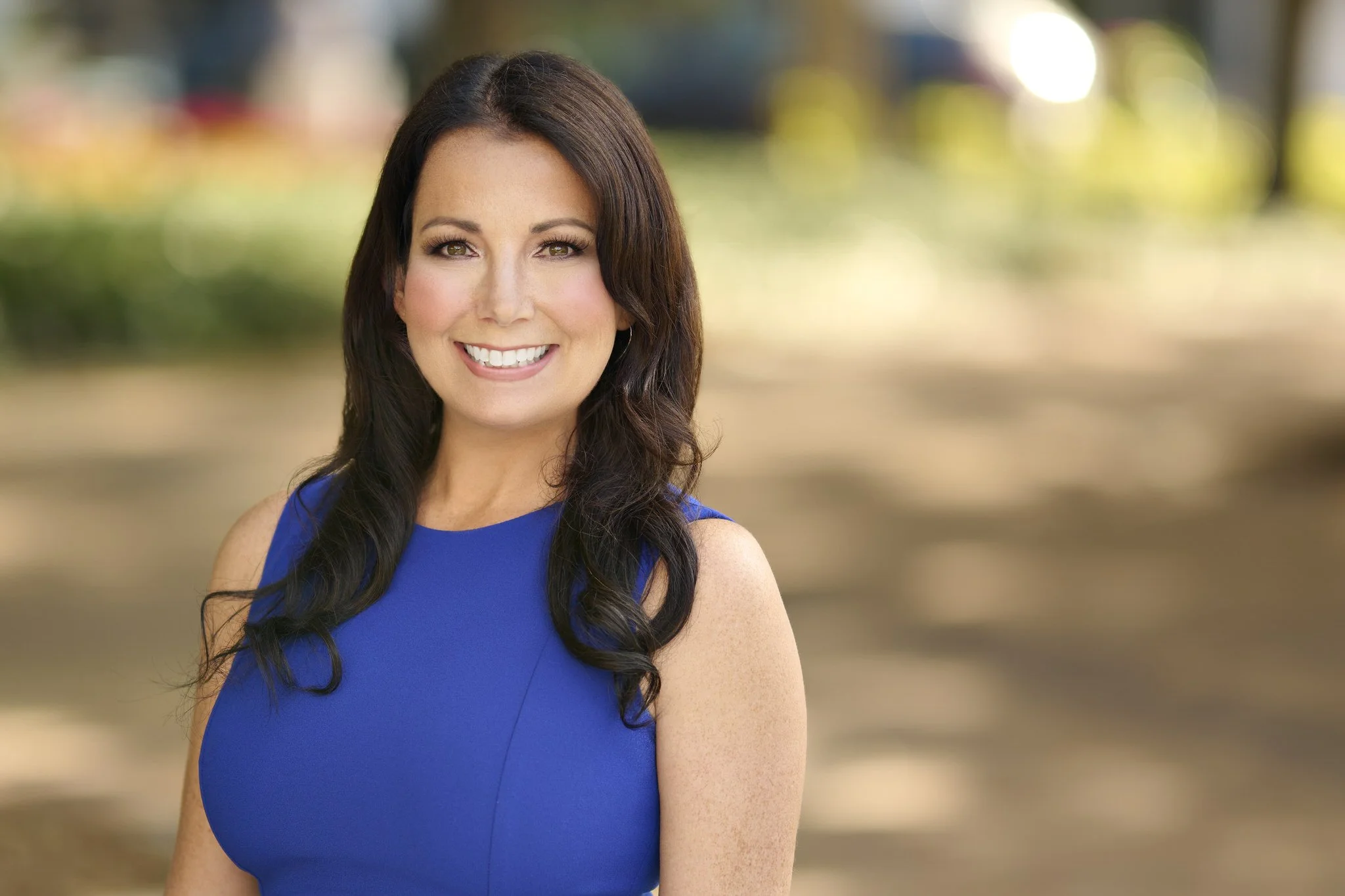 Professional woman in blue dress photographed outdoors for a Sarasota business headshot session by SRQ Headshots.
