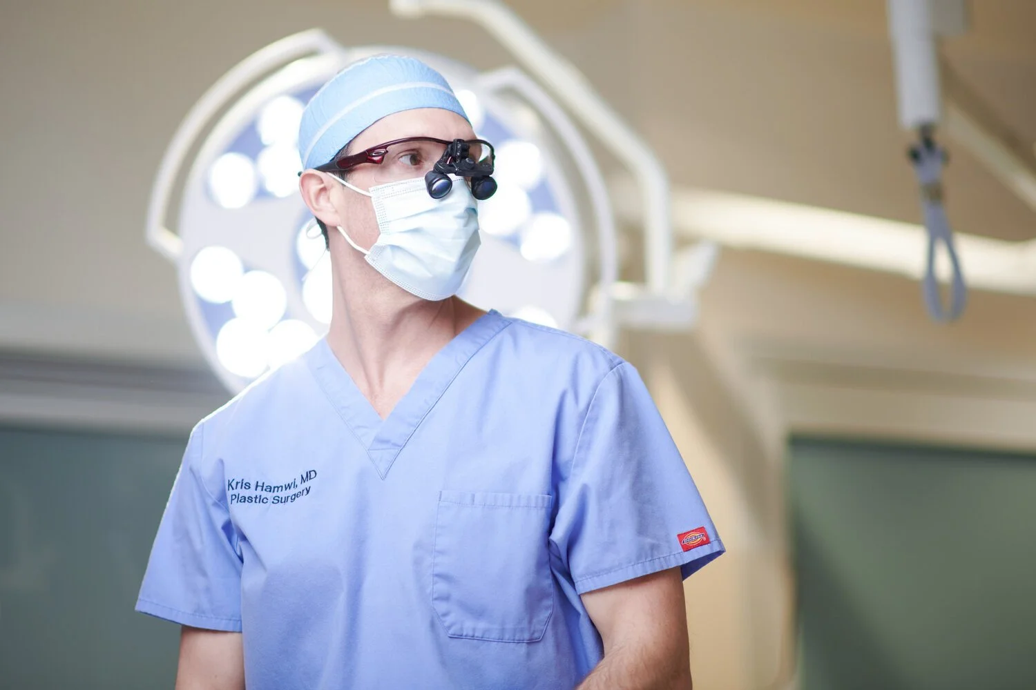 Plastic surgeon in surgical scrubs photographed in an operating room during a professional medical branding headshot session in Sarasota by SRQ Headshots.