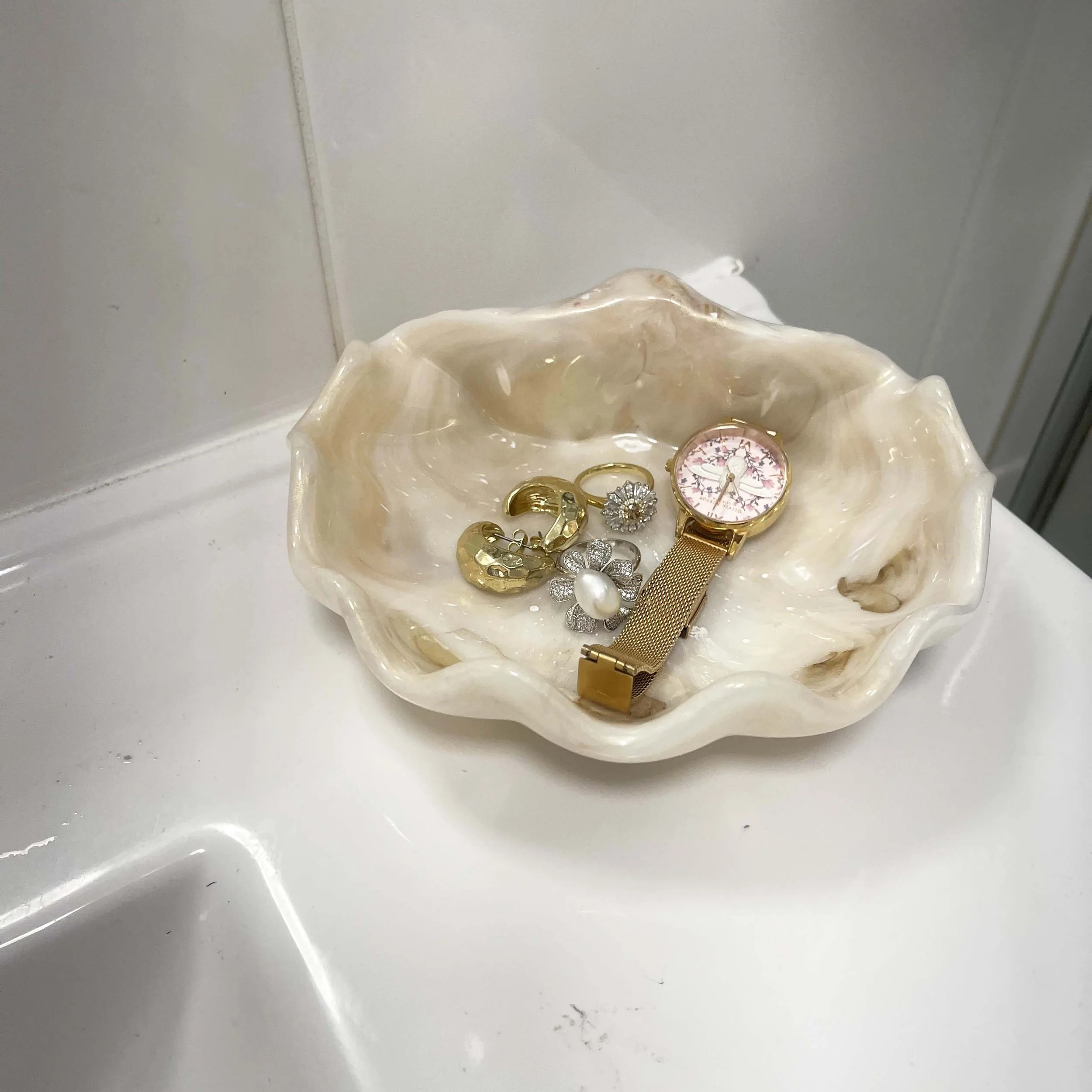 large conch shell resin sandy closeup in bathroom.jpg