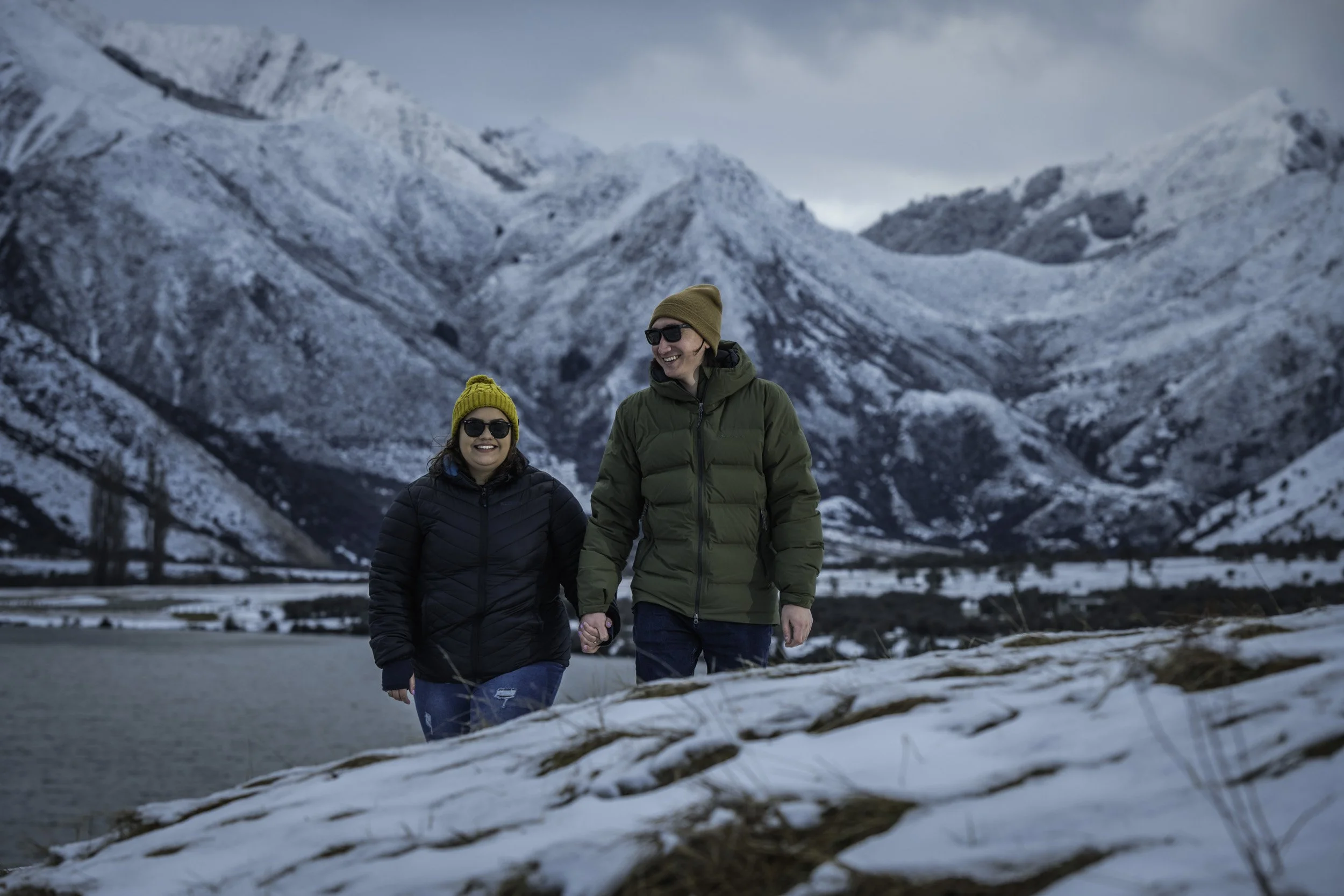 Couple during a winter proposal at Moke Lake near Queenstown, professionally photographed