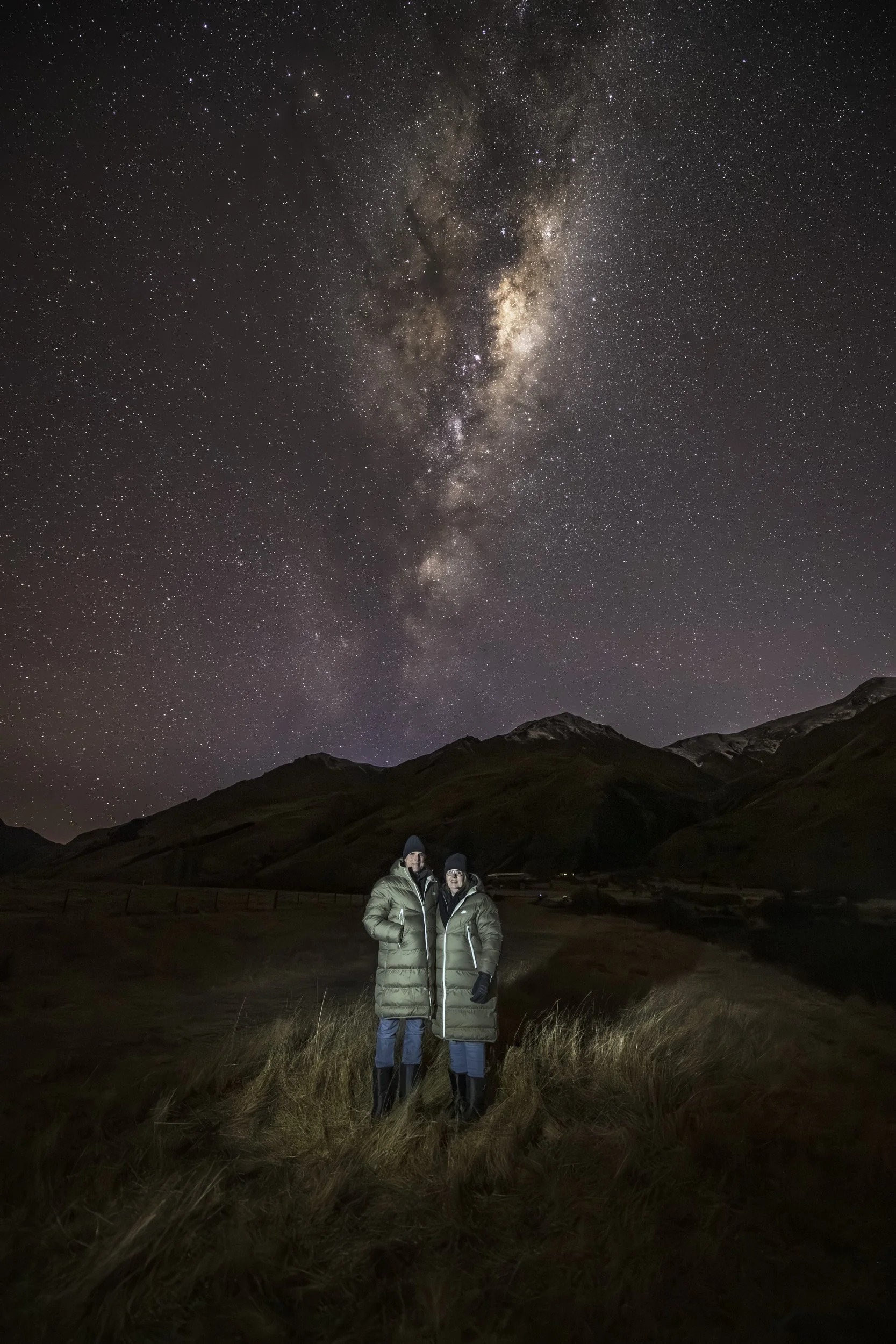 Astro portrait of an Australian Couple under kā whetū, Southern night sky at Moke Lake, AuthenticAs Queenstown